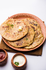 Aloo Paratha / Indian Potato stuffed Flatbread. Served with fresh curd and tomato ketchup. selective focus