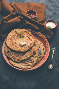 Aloo Paratha / Indian Potato stuffed Flatbread. Served with fresh curd and tomato ketchup. selective focus