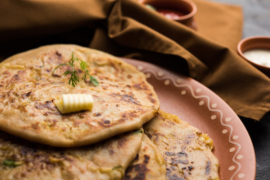 Aloo Paratha / Indian Potato stuffed Flatbread. Served with fresh curd and tomato ketchup. selective focus