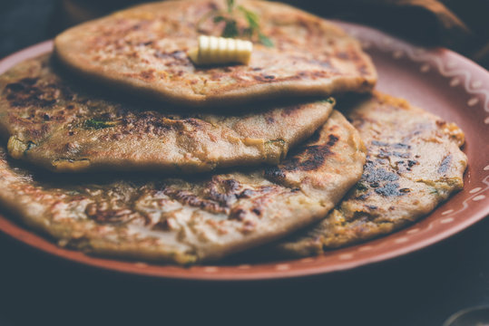 Aloo Paratha / Indian Potato stuffed Flatbread. Served with fresh curd and tomato ketchup. selective focus