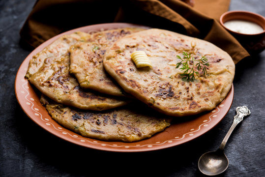 Aloo Paratha / Indian Potato stuffed Flatbread. Served with fresh curd and tomato ketchup. selective focus