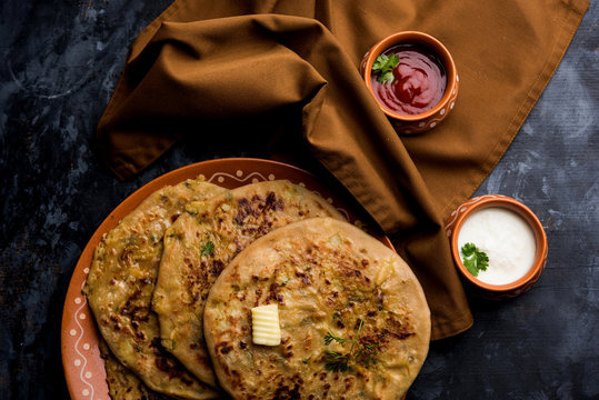 Aloo Paratha / Indian Potato stuffed Flatbread. Served with fresh curd and tomato ketchup. selective focus