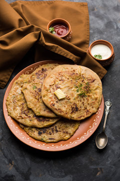 Aloo Paratha / Indian Potato stuffed Flatbread. Served with fresh curd and tomato ketchup. selective focus