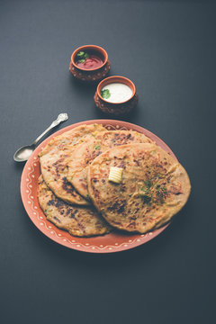 Aloo Paratha / Indian Potato stuffed Flatbread. Served with fresh curd and tomato ketchup. selective focus