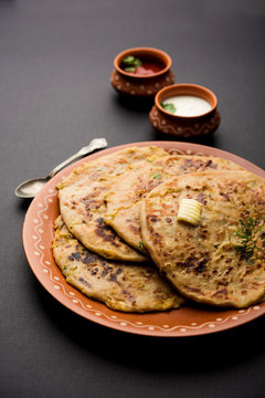 Aloo Paratha / Indian Potato stuffed Flatbread. Served with fresh curd and tomato ketchup. selective focus