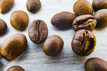 Close Up on Roasted Caffee Beans on the white wooden plate