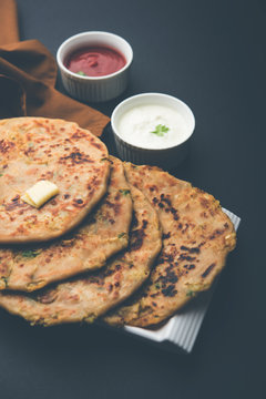 Aloo Paratha / Indian Potato stuffed Flatbread. Served with fresh curd and tomato ketchup. selective focus