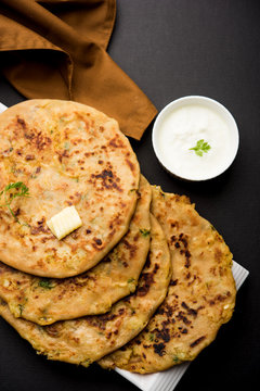 Aloo Paratha / Indian Potato stuffed Flatbread. Served with fresh curd and tomato ketchup. selective focus