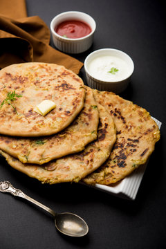 Aloo Paratha / Indian Potato stuffed Flatbread. Served with fresh curd and tomato ketchup. selective focus