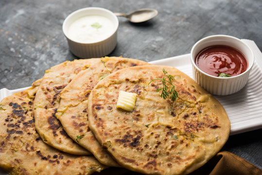 Aloo Paratha / Indian Potato stuffed Flatbread. Served with fresh curd and tomato ketchup. selective focus