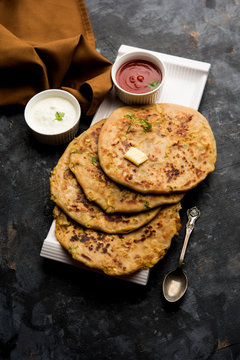 Aloo Paratha / Indian Potato stuffed Flatbread. Served with fresh curd and tomato ketchup. selective focus