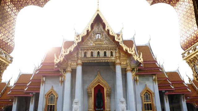 4K footage. The Marble Temple or Wat Benchamabophit Dusit Wanaram in morning time with sun beam on top of church, famous landmark place for tourist sight seeing in Bangkok Thailand