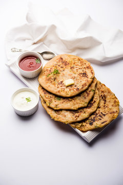 Aloo Paratha / Indian Potato stuffed Flatbread. Served with fresh curd and tomato ketchup. selective focus
