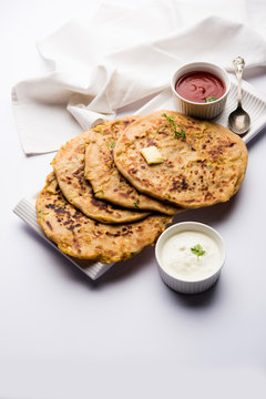 Aloo Paratha / Indian Potato stuffed Flatbread. Served with fresh curd and tomato ketchup. selective focus
