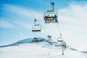 Fototapeta People on ski lift in winter ski resort obraz
