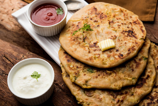 Aloo Paratha / Indian Potato stuffed Flatbread. Served with fresh curd and tomato ketchup. selective focus