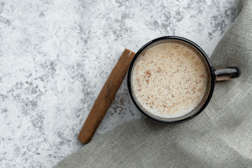 Cup of milk with cinnamon. Top view.