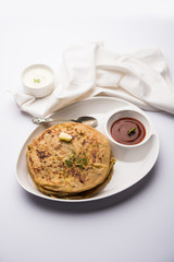 Aloo Paratha / Indian Potato stuffed Flatbread. Served with fresh curd and tomato ketchup. selective focus