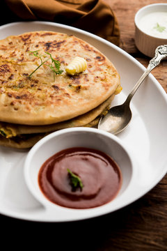 Aloo Paratha / Indian Potato stuffed Flatbread. Served with fresh curd and tomato ketchup. selective focus