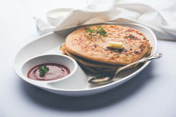 Aloo Paratha / Indian Potato stuffed Flatbread. Served with fresh curd and tomato ketchup. selective focus