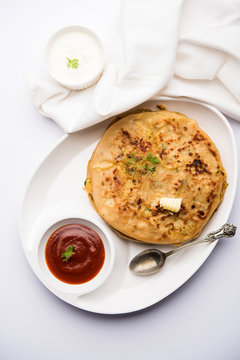 Aloo Paratha / Indian Potato stuffed Flatbread. Served with fresh curd and tomato ketchup. selective focus
