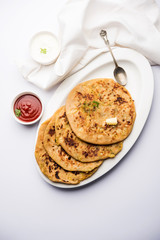 Aloo Paratha / Indian Potato stuffed Flatbread. Served with fresh curd and tomato ketchup. selective focus