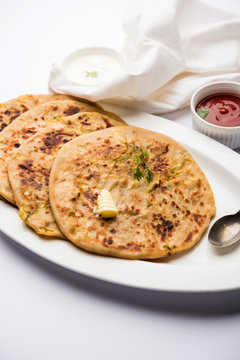 Aloo Paratha / Indian Potato stuffed Flatbread. Served with fresh curd and tomato ketchup. selective focus