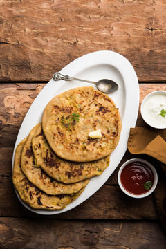 Aloo Paratha / Indian Potato stuffed Flatbread. Served with fresh curd and tomato ketchup. selective focus