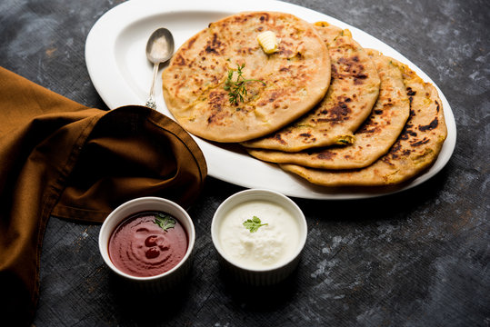 Aloo Paratha / Indian Potato stuffed Flatbread. Served with fresh curd and tomato ketchup. selective focus