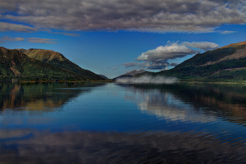 View over a lake with mountains at the blue hour