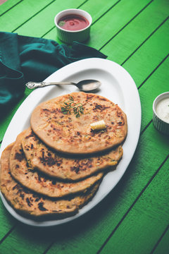 Aloo Paratha / Indian Potato stuffed Flatbread. Served with fresh curd and tomato ketchup. selective focus