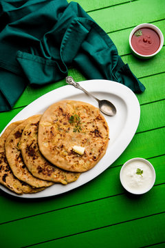 Aloo Paratha / Indian Potato stuffed Flatbread. Served with fresh curd and tomato ketchup. selective focus