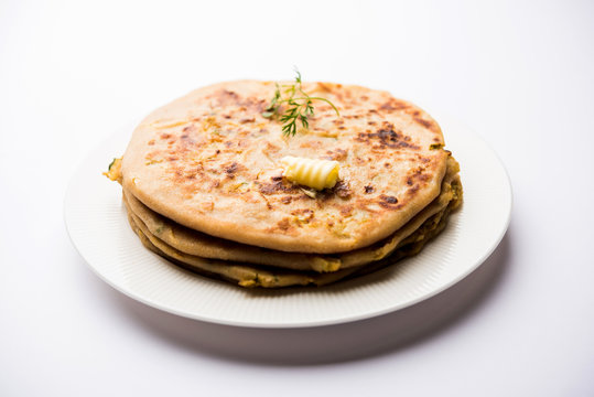 Aloo Paratha / Indian Potato stuffed Flatbread. Served with fresh curd and tomato ketchup. selective focus