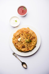 Aloo Paratha / Indian Potato stuffed Flatbread. Served with fresh curd and tomato ketchup. selective focus