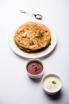 Aloo Paratha / Indian Potato stuffed Flatbread. Served with fresh curd and tomato ketchup. selective focus
