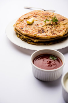 Aloo Paratha / Indian Potato stuffed Flatbread. Served with fresh curd and tomato ketchup. selective focus