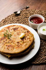 Aloo Paratha / Indian Potato stuffed Flatbread. Served with fresh curd and tomato ketchup. selective focus