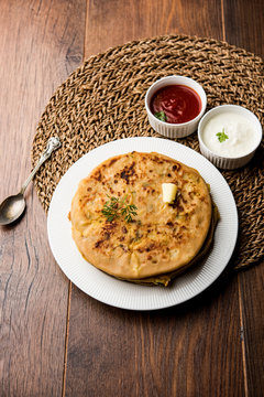 Aloo Paratha / Indian Potato stuffed Flatbread. Served with fresh curd and tomato ketchup. selective focus