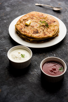 Aloo Paratha / Indian Potato stuffed Flatbread. Served with fresh curd and tomato ketchup. selective focus
