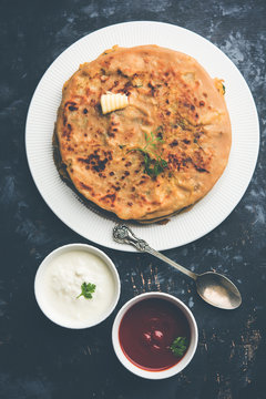 Aloo Paratha / Indian Potato stuffed Flatbread. Served with fresh curd and tomato ketchup. selective focus