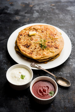 Aloo Paratha / Indian Potato stuffed Flatbread. Served with fresh curd and tomato ketchup. selective focus