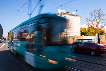 The motion of a blurred streetcar in the daytime.