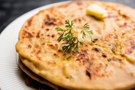 Aloo Paratha / Indian Potato stuffed Flatbread. Served with fresh curd and tomato ketchup. selective focus