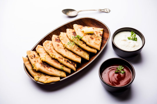 Aloo Paratha / Indian Potato stuffed Flatbread. Served with fresh curd and tomato ketchup. selective focus
