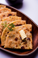 Aloo Paratha / Indian Potato stuffed Flatbread. Served with fresh curd and tomato ketchup. selective focus