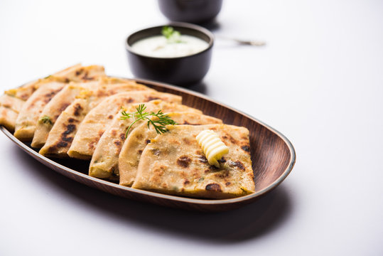 Aloo Paratha / Indian Potato stuffed Flatbread. Served with fresh curd and tomato ketchup. selective focus