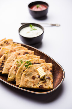 Aloo Paratha / Indian Potato stuffed Flatbread. Served with fresh curd and tomato ketchup. selective focus