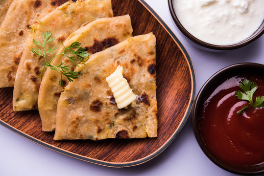 Aloo Paratha / Indian Potato stuffed Flatbread. Served with fresh curd and tomato ketchup. selective focus
