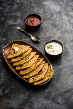 Aloo Paratha / Indian Potato stuffed Flatbread. Served with fresh curd and tomato ketchup. selective focus