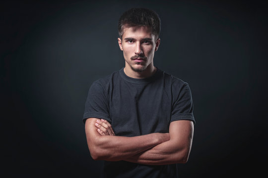 portrait of a strong young man with black background